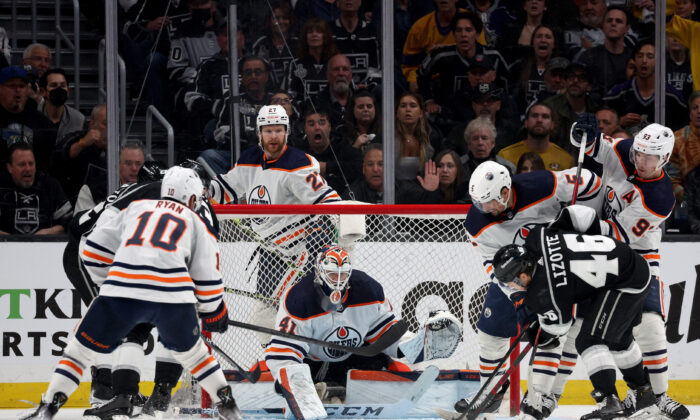 Mike Smith #41 of the Edmonton Oilers covers the bottom of the net in front of Blake Lizotte #46 of the Los Angeles Kings during the third period in a 4-2 Oilers win in Game Six of the First Round of the 2022 Stanley Cup Playoffs at Crypto.com Arena, in Los Angeles, on May 12, 2022. (Harry How/Getty Images)
