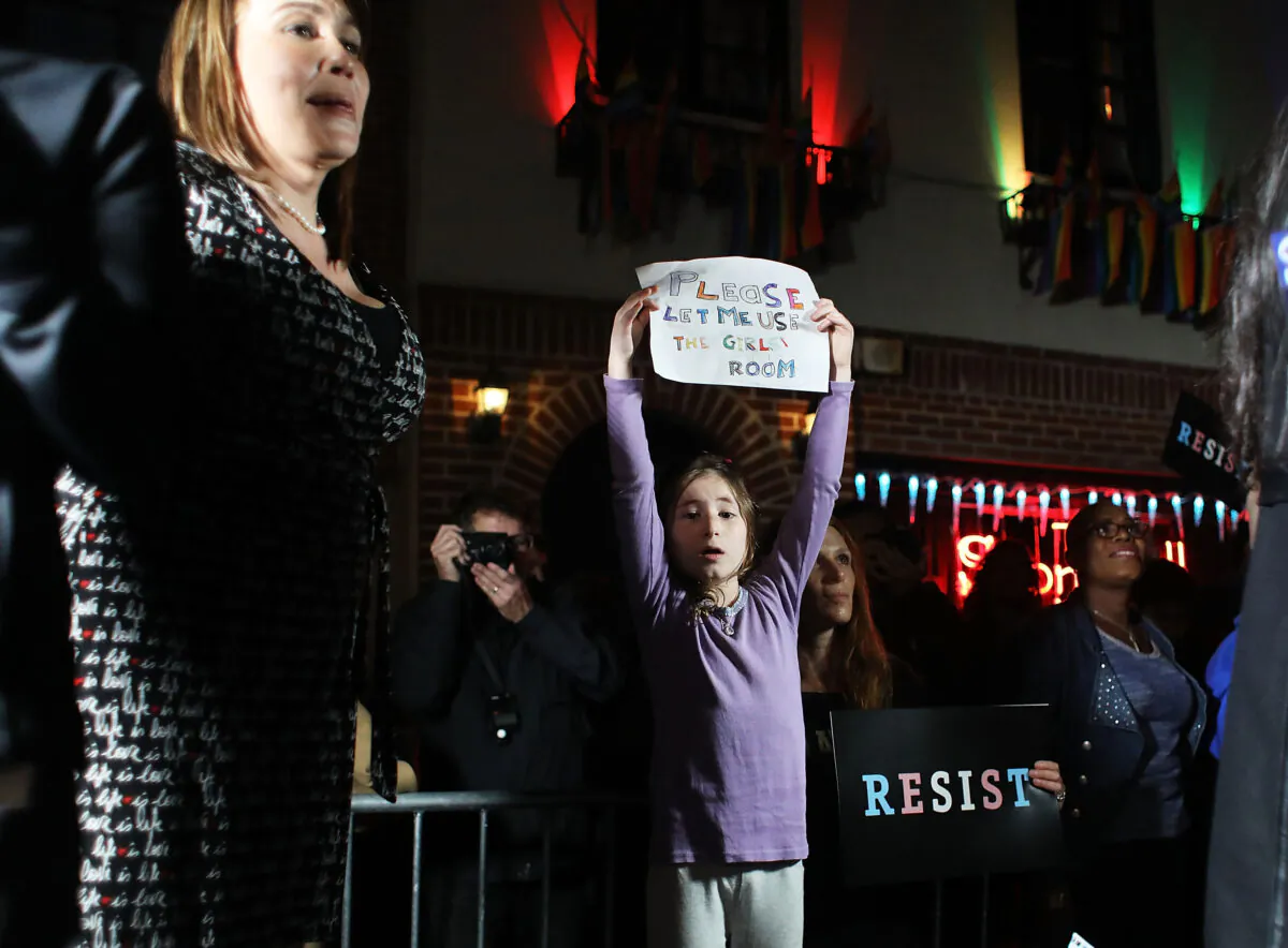 Activists and members of the transgender community protest a Trump administration announcement that rescinds an Obama-era order allowing transgender students to use school bathrooms matching their gender identities, at the Stonewall Inn in New York on Feb. 23, 2017. (Spencer Platt/Getty Images)