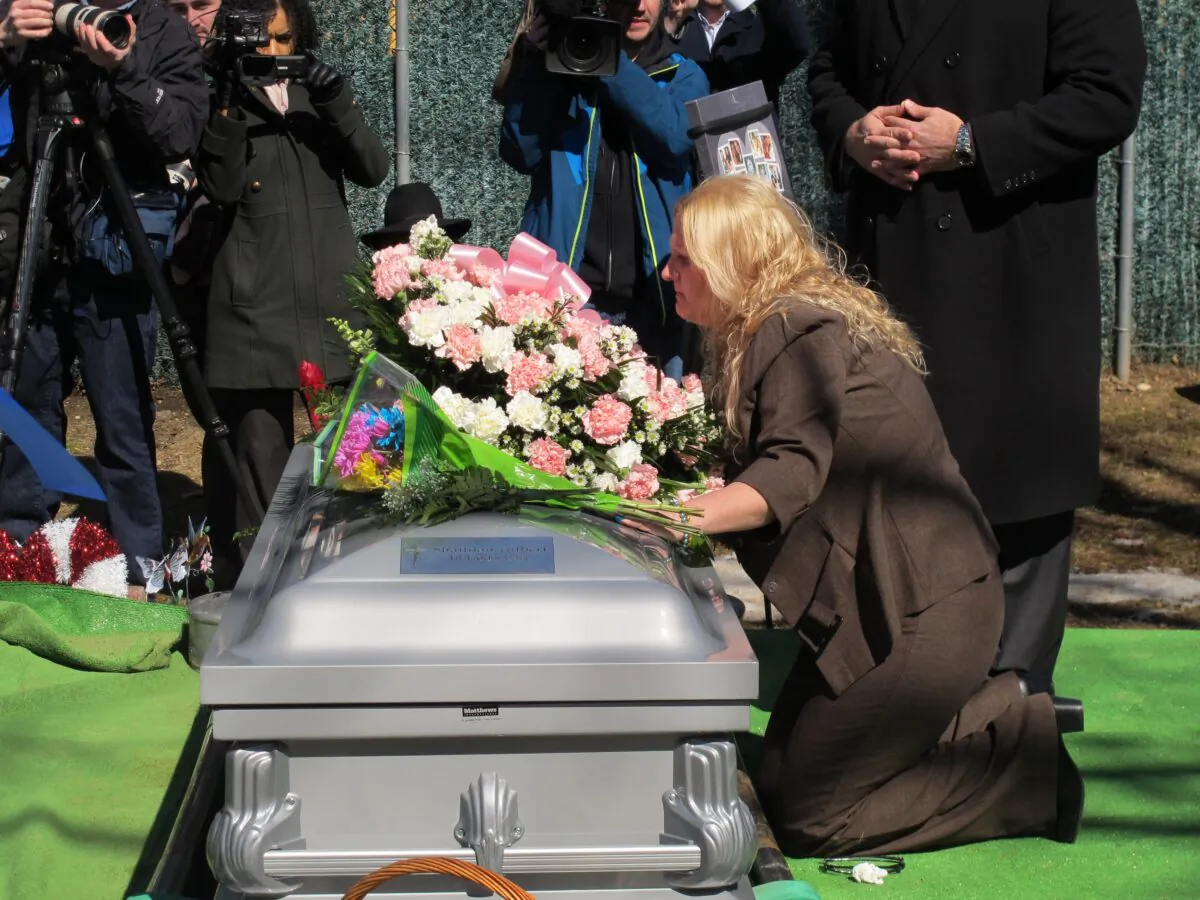 Mari Gilbert prays over the coffin of her daughter, Shannan Gilbert, at Amityville Cemetery in Amityville, New York, on March 12, 2015. (Frank Eltman/AP Photo)