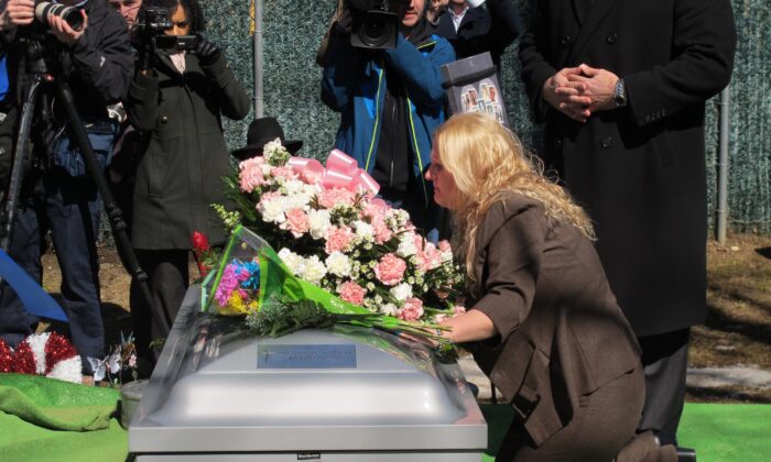 Mari Gilbert prays over the coffin of her daughter, Shannan Gilbert, at Amityville Cemetery in Amityville, New York, on March 12, 2015. (Frank Eltman/AP Photo)