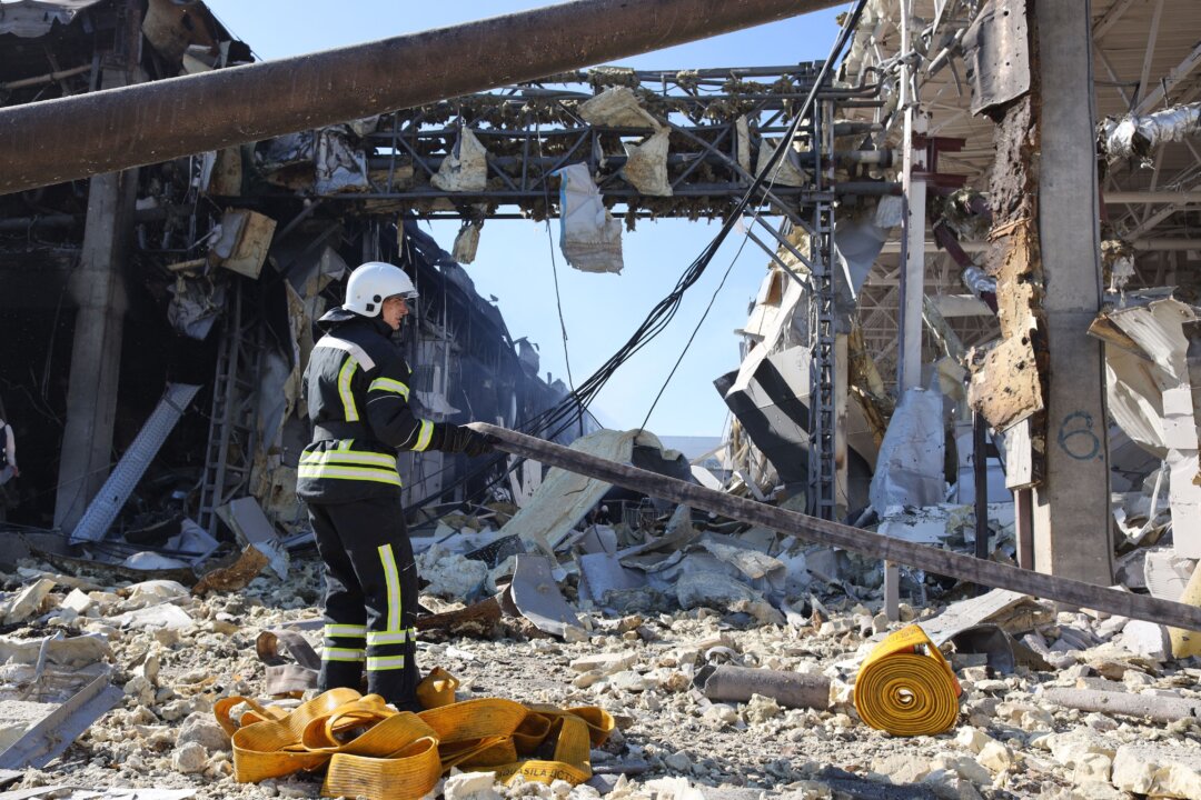 A rescue worker gestures in front of the shopping and entertainment center in the Ukrainian Black Sea city of Odesa, destroyed after Russian missiles strike late on May 9, 2022. (Oleksandr Gimanov/AFP via Getty Images)