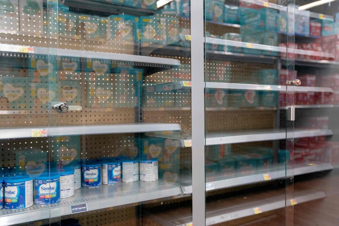 Grocery store shelves where baby formula is typically stocked are locked and nearly empty in Washington on May 11, 2022. (Stefani Reynolds/AFP via Getty Images)
