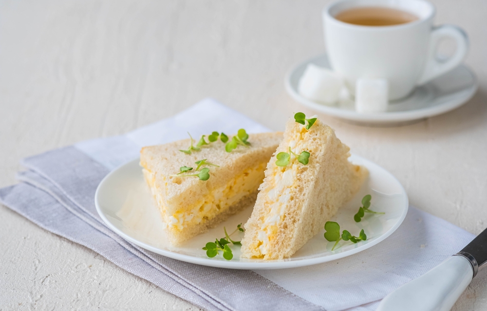 Tea,Triangular,Sandwiches,With,Egg,Salad,On,A,White,Plate
