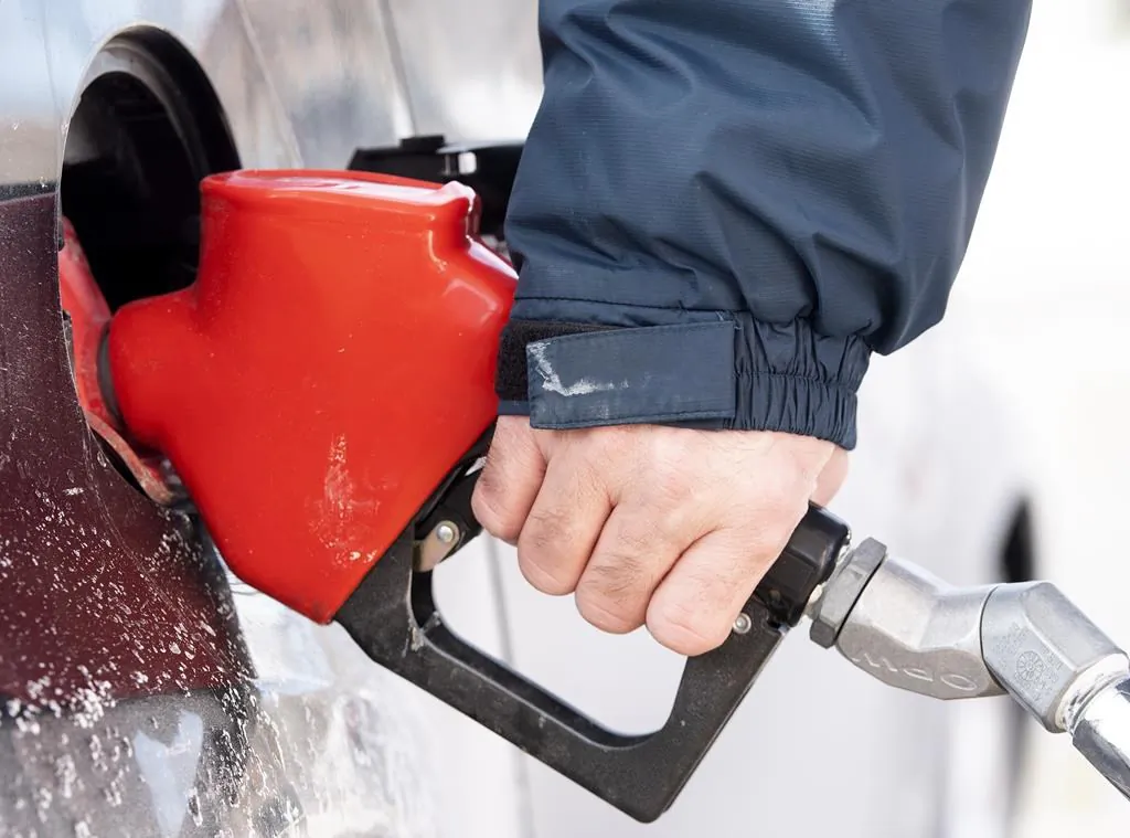 A man pumps gas in Montreal on Mar. 4, 2022. (The Canadian Press/Graham Hughes)