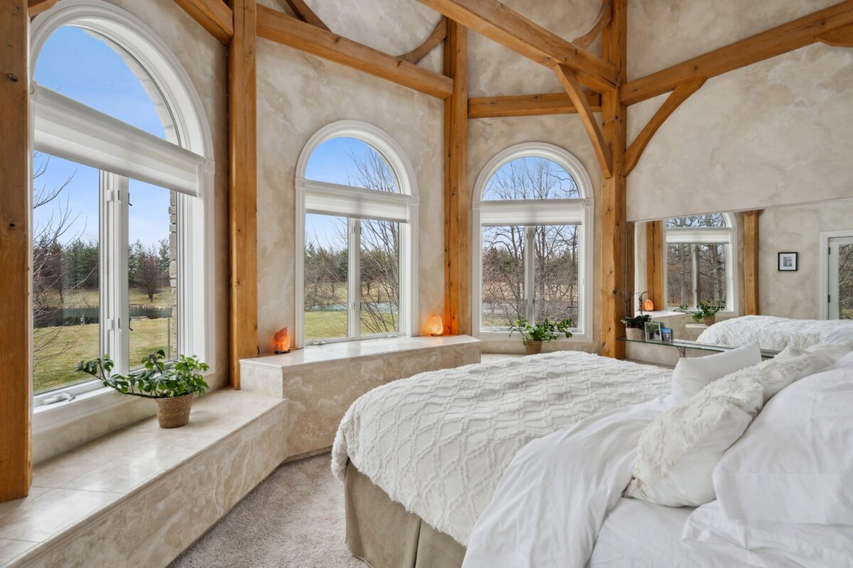 Upstairs, a massive master suite looks out over the 20-acre farm through bay windows. The suite has a sumptuous bath area, a large walk-in closet, and a sitting area as well. (Baird & Warner)