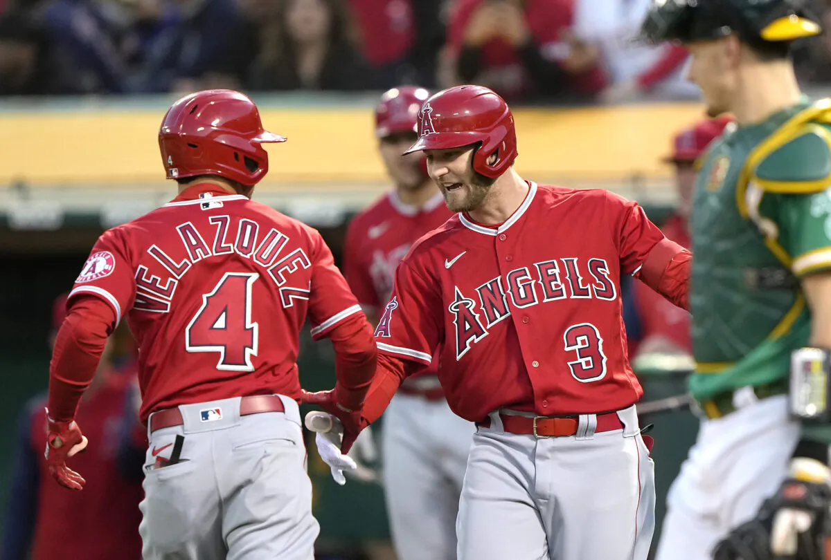 Andrew Velazquez #4 of the Los Angeles Angels is congratulated by Taylor Ward #3 after Velazquez hit a solo home run against the Oakland Athletics in the top of the fifth inning at RingCentral Coliseum, in Oakland, Calif., on May 13, 2022. (Thearon W. Henderson/Getty Images)