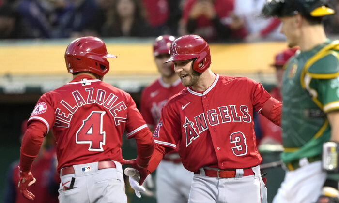 Andrew Velazquez #4 of the Los Angeles Angels is congratulated by Taylor Ward #3 after Velazquez hit a solo home run against the Oakland Athletics in the top of the fifth inning at RingCentral Coliseum, in Oakland, Calif., on May 13, 2022. (Thearon W. Henderson/Getty Images)