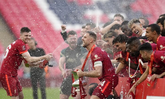 Liverpool players celebrate at the end of the English FA Cup final soccer match between Chelsea and Liverpool, at Wembley stadium in London on May 14, 2022. (Kirsty Wigglesworth/AP Photo)