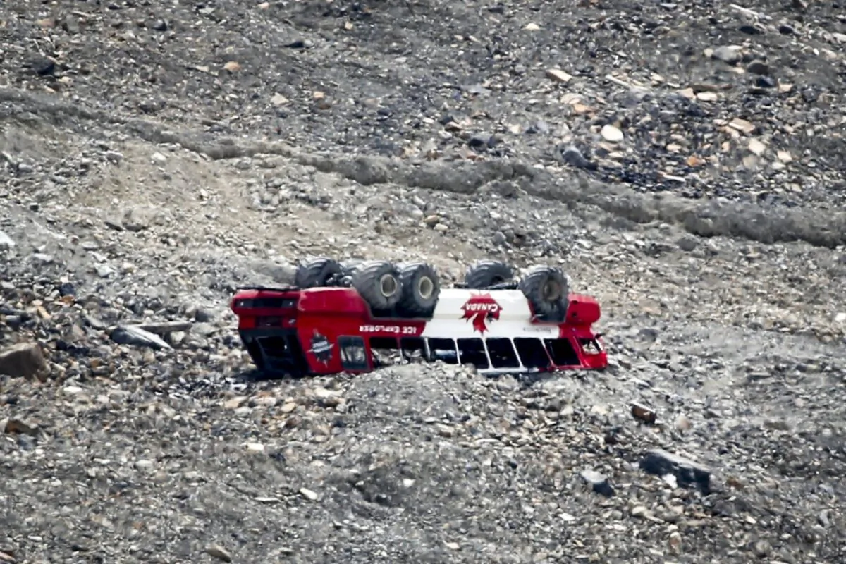 A rolled-over tour bus rests where it fell on the Columbia Icefield near Jasper, Alta., July 19, 2020. (The Canadian Press/Jeff McIntosh)