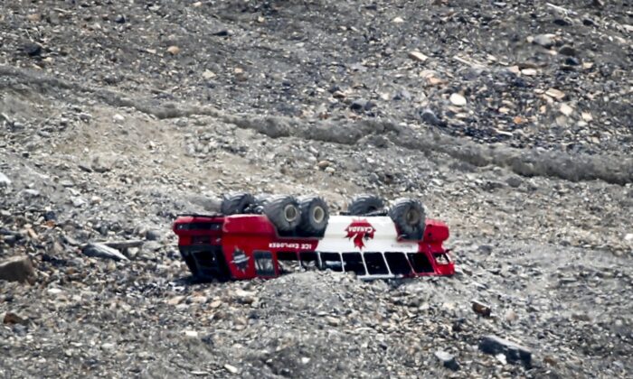 A rolled-over tour bus rests where it fell on the Columbia Icefield near Jasper, Alta., July 19, 2020. (The Canadian Press/Jeff McIntosh)