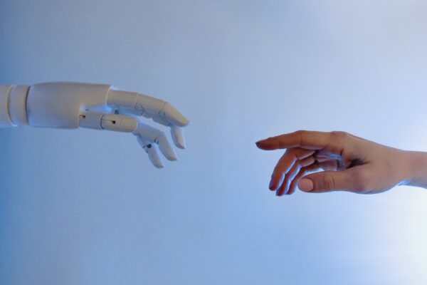 person reaching out for robot