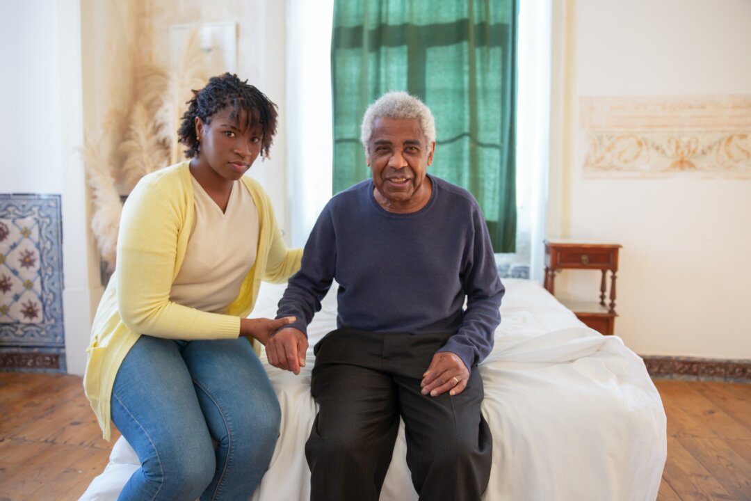Stock photo of a woman taking care of an elderly man. (Kampus Production/Pexels)