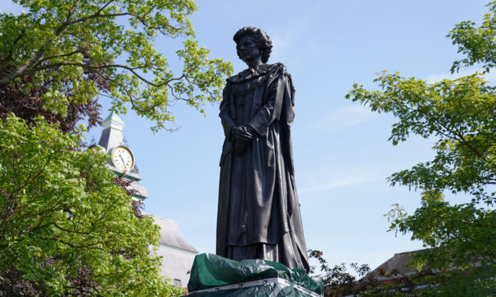 Plastic sheeting covers the plinth of the newly installed statue of Baroness Margaret Thatcher in her home town of Grantham, Lincolnshire, England, on May 15, 2022. (Joe Giddens/PA Media)

