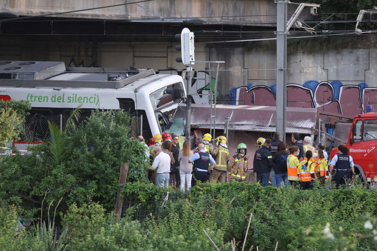 Spanish first responders attend to the scene, after a commuter train and a goods train collided, on the outskirts of Barcelona, Spain, on May 16, 2022. (Nacho Doce/Reuters)