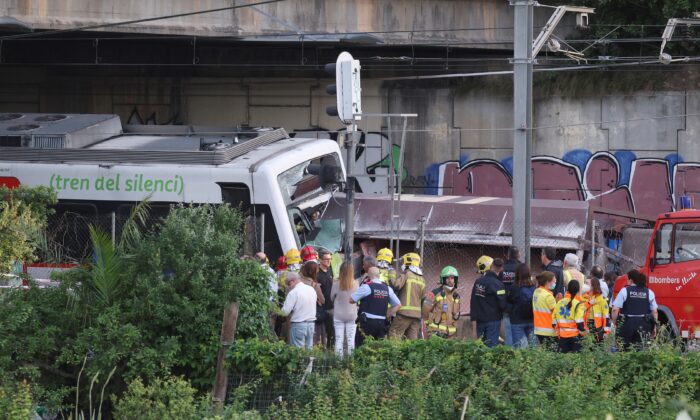 Spanish first responders attend to the scene, after a commuter train and a goods train collided, on the outskirts of Barcelona, Spain, on May 16, 2022. (Nacho Doce/Reuters)