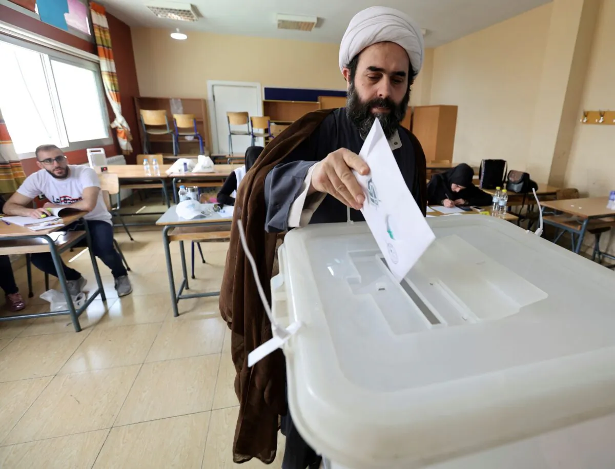 A muslim cleric casts his vote at a polling station, during the parliamentary election, in Khiam, near the border with Israel, southern Lebanon on May 15, 2022. (Aziz Taher/Reuters)