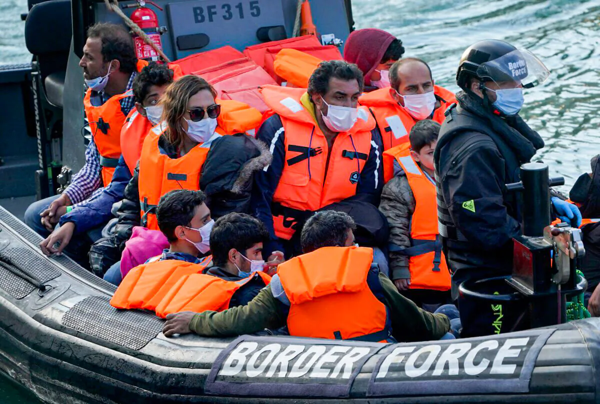 A group of people who crossed the channel from France are brought in to Dover, England, on Sept. 7, 2021. (Gareth Fuller/PA)