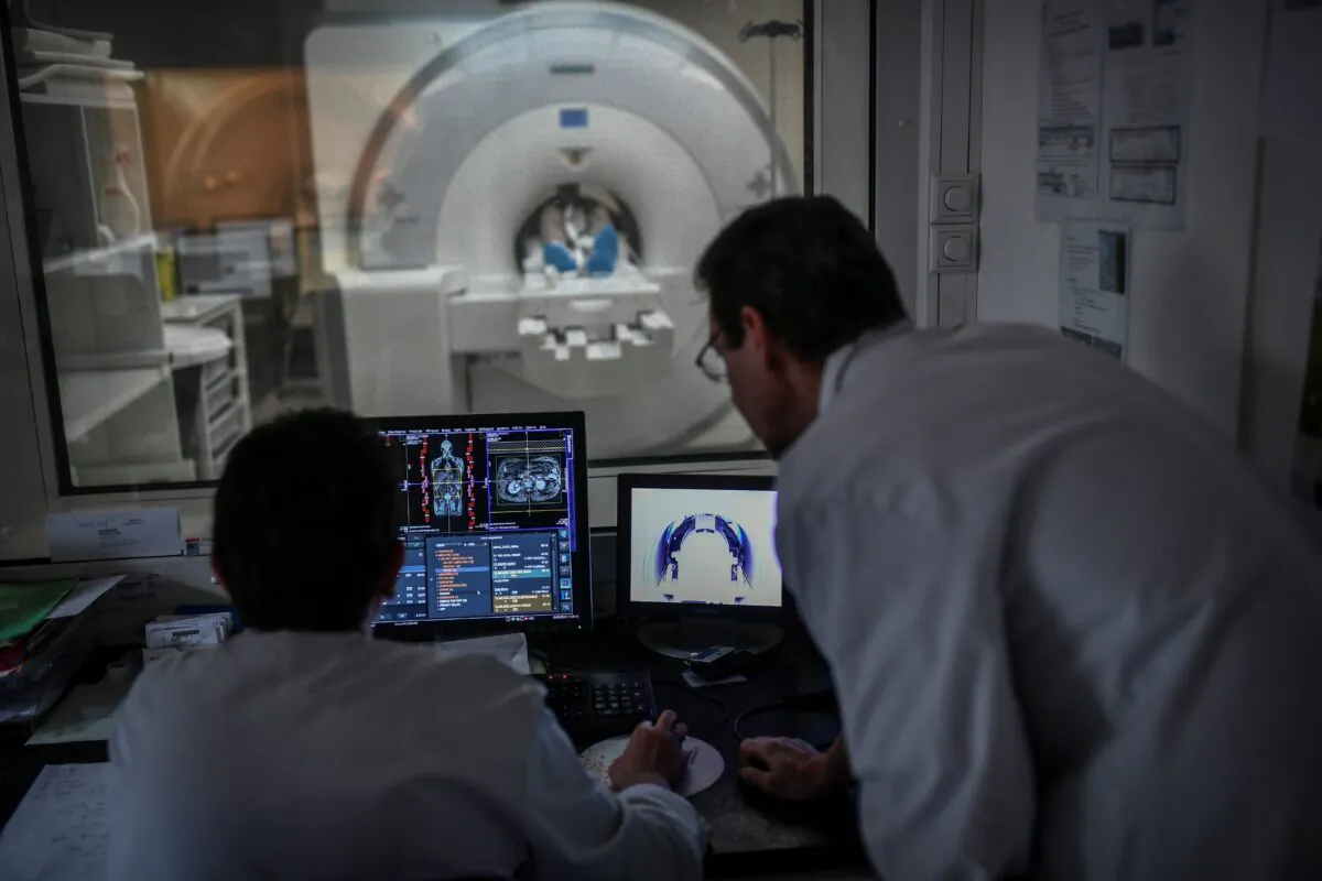 Radiologists supervise a patient undergoing an MRI using a new generation of hybrid camera named PET-MRI scanner at the Mondor Hospital in Creteil, France, on June 5, 2019. (Stephane de Sakutin/AFP via Getty Images)