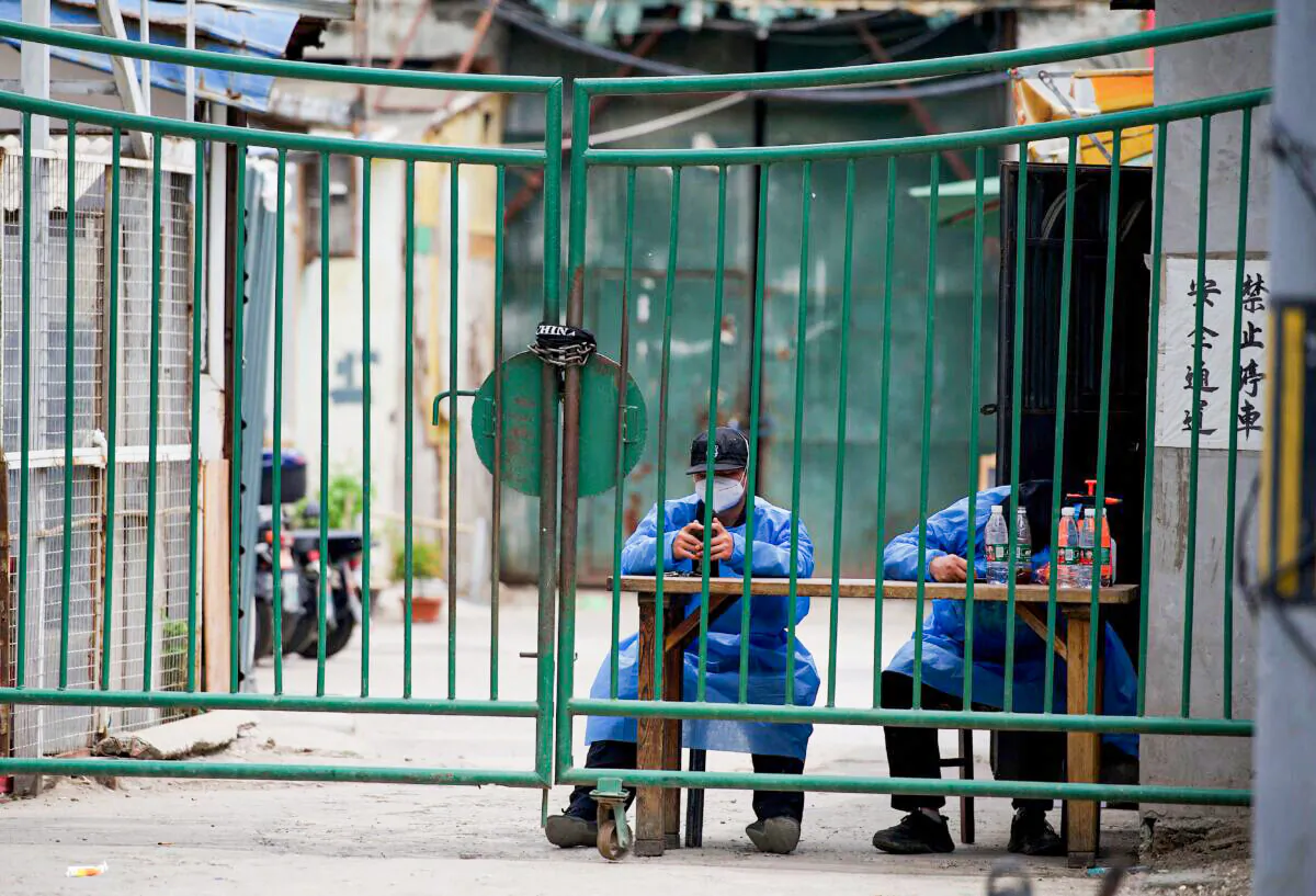 Security guards man a residential area under a lockdown in Beijing on May 11, 2022. (Noel Celis/AFP via Getty Images)