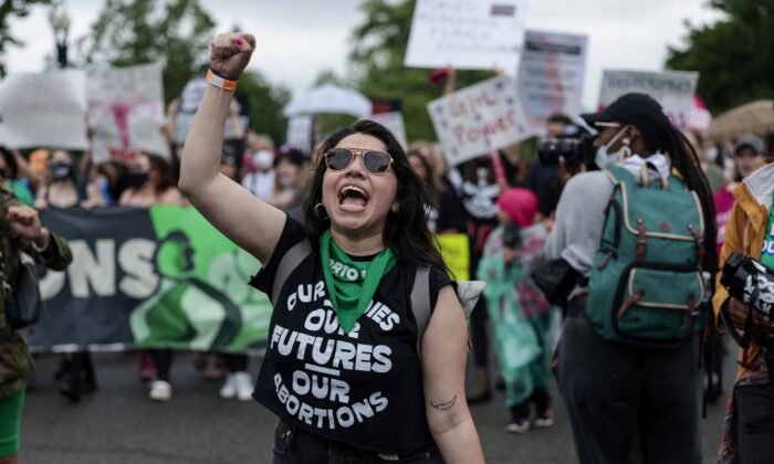 Pro-abortion protesters yell as they march along Constitution Avenue during the Bans Off Our Bodies march in Washington on May 14, 2022. (Anna Moneymaker/Getty Images)