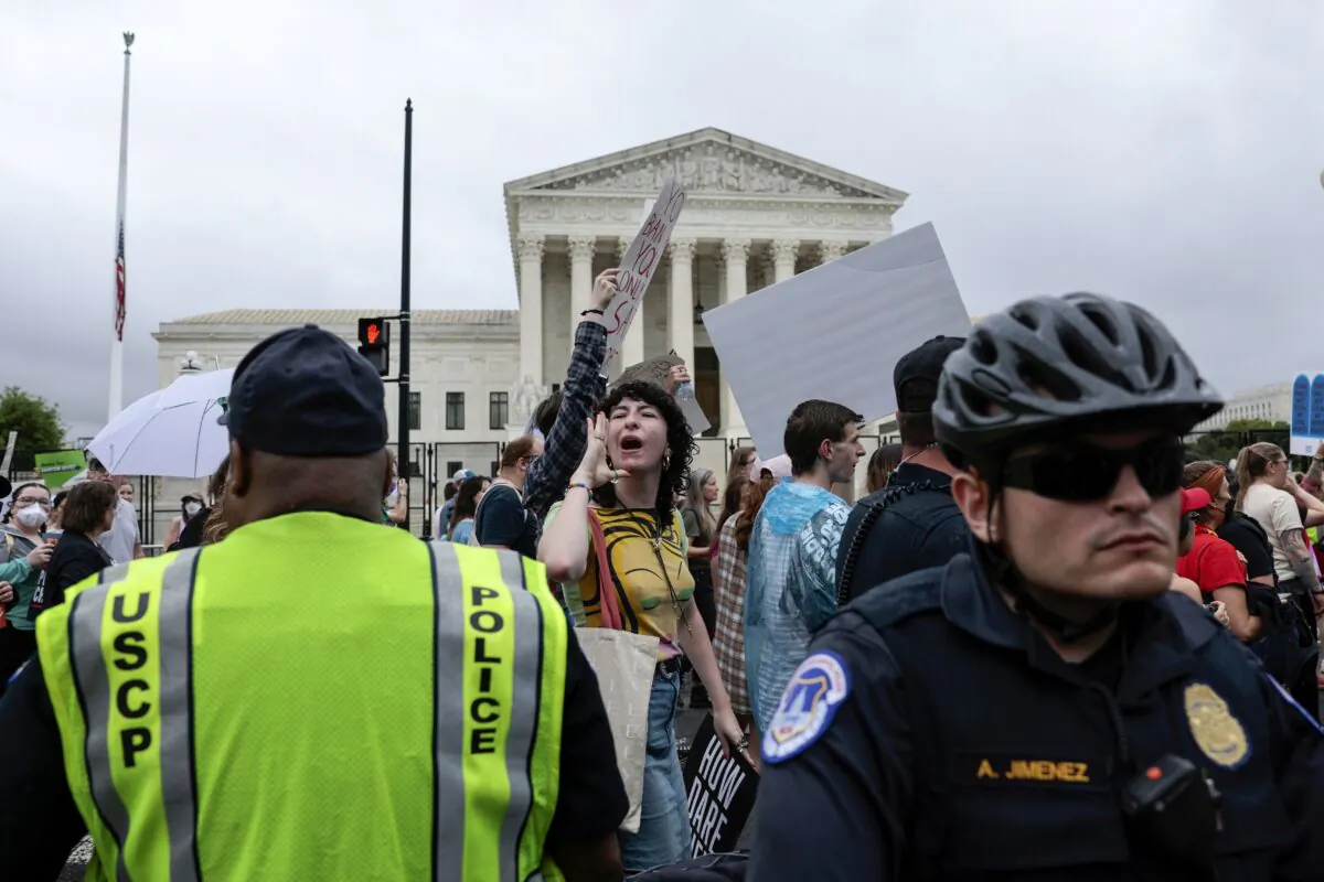 Police keep watch as pro-abortion protesters march in front of the U.S. Supreme Court during a Bans Off Our Bodies march in Washington on May 14, 2022. (Anna Moneymaker/Getty Images)