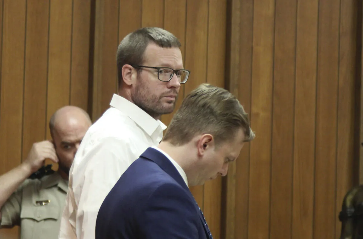 Michael Lang (L) stands with his defense attorney Konrad Kamizelich in Webster City, Iowa, on May 10, 2022. (Jeff Reinitz/The Courier via AP)