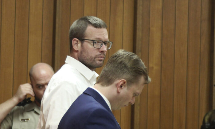 Michael Lang (L) stands with his defense attorney Konrad Kamizelich in Webster City, Iowa, on May 10, 2022. (Jeff Reinitz/The Courier via AP)