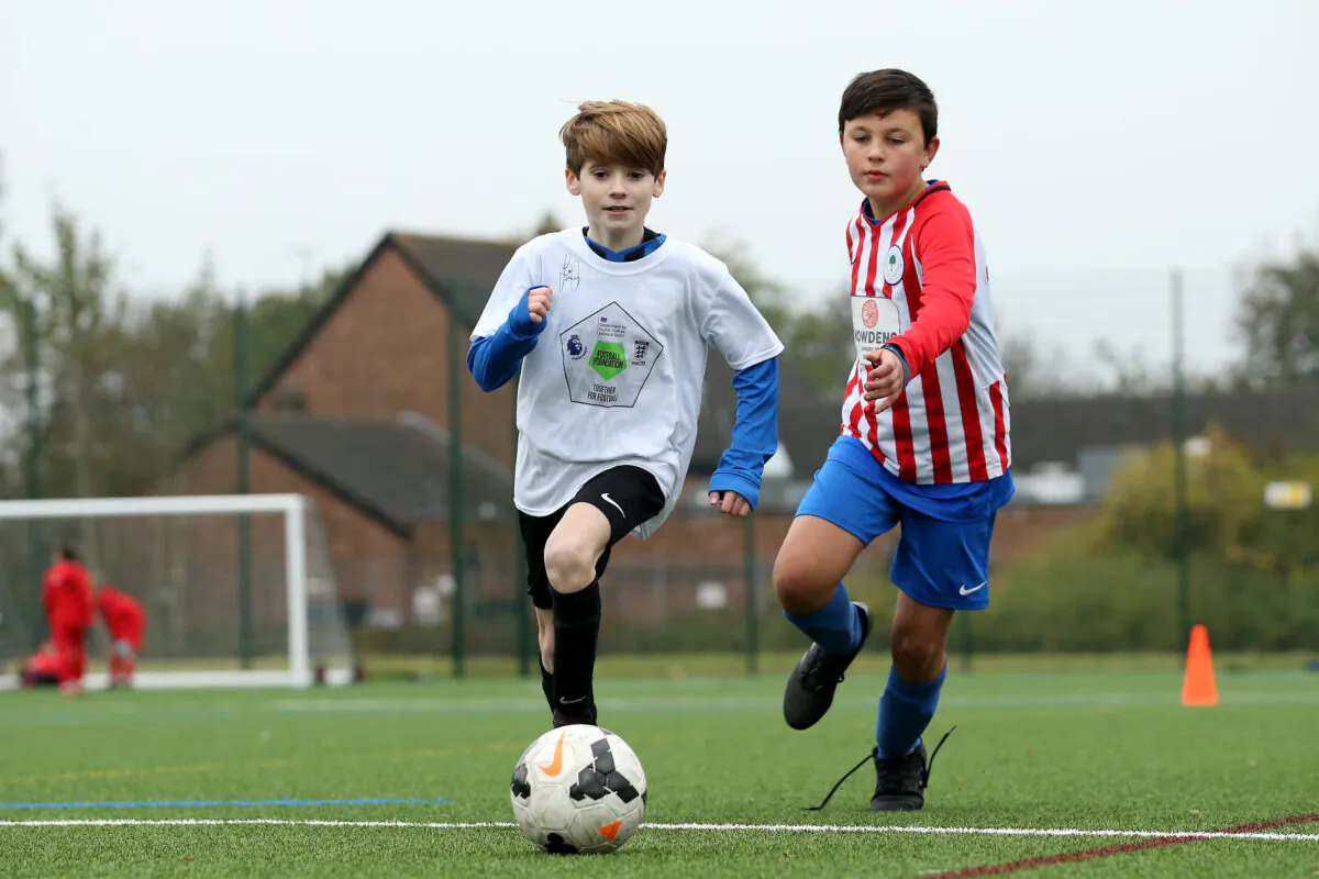 Local children take part in activities during a Premier League Football Foundation Hub Opening at Jericho Lane Playing Fields in Liverpool, England, on Oct. 31, 2019. (Jan Kruger/Getty Images for Premier League)