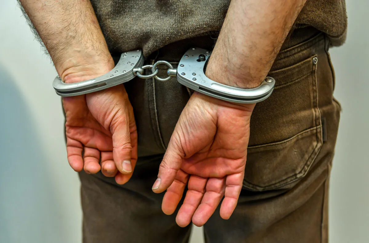 A man in handcuffs in an undated file photo. (Philippe Huguen/AFP/Getty Images)