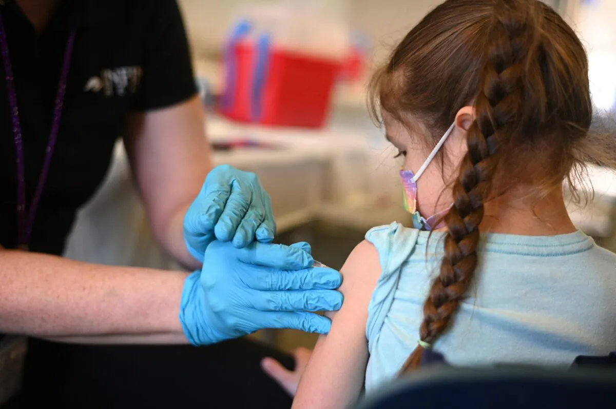 A nurse administers a paediatric dose of the COVID-19 vaccine to a girl at a L.A. Care Health Plan vaccination clinic at Los Angeles Mission College in Los Angeles, Calif., Jan. 19, 2022. (Robyn Beck/AFP via Getty Images)