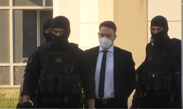 A Greek pilot and flight instructor, arrived at Greece court under heavy police guard on May 16, 2022. (AP/Screenshot via The Epoch Times)

