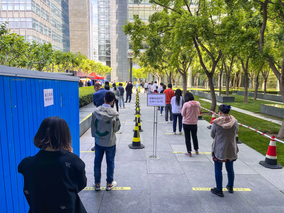 People queue up for COVID-19 nucleic acid tests during a new round of nucleic acid testing amid the COVID-19 resurgence in Beijing, China, on May 11, 2022. (VCG/VCG via Getty Images)