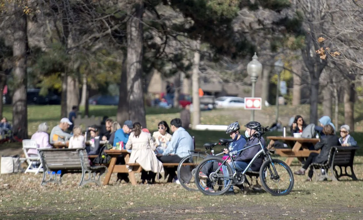 People gather in a park on a warm fall day in Montreal on Nov. 7, 2020. (The Canadian Press/Graham Hughes)