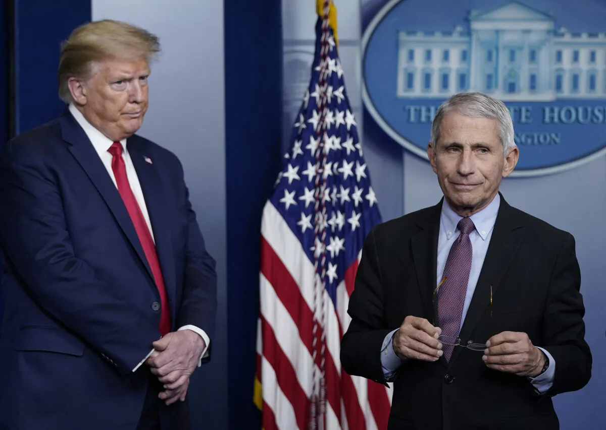 Dr. Anthony Fauci (R), then-director of the National Institute of Allergy and Infectious Diseases, and then-President Donald Trump participate in the daily coronavirus task force briefing at the White House in Washington on April 22, 2020. (Drew Angerer/Getty Images)