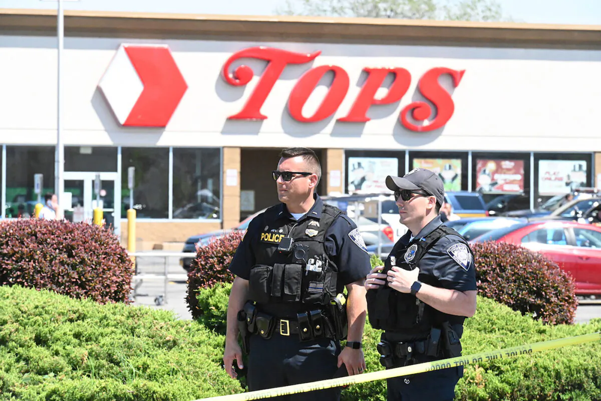 Police stand in front of a Tops Grocery store in Buffalo, N.Y., on May 15, 2022, the day after a mass shooting inside the supermarket left 10 people dead and three wounded. (Usman Khan/AFP via Getty Images)