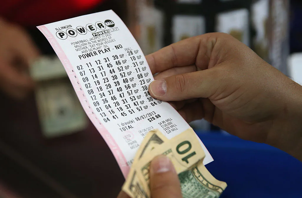 A customer at a 7-Eleven store checks the numbers on his Powerball lottery ticket on August 7, 2013 in Chicago, Illinois. (Photo by Scott Olson/Getty Images)
