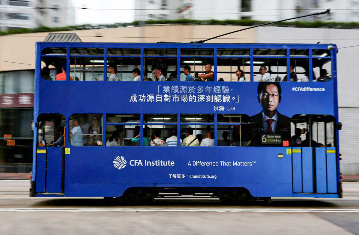 A bus with an advertisement for CFA Institute, featuring Hao Hong, head of research at Bocom International, drives past in Hong Kong, on Oct. 6, 2016. (Bobby Yip/Reuters)