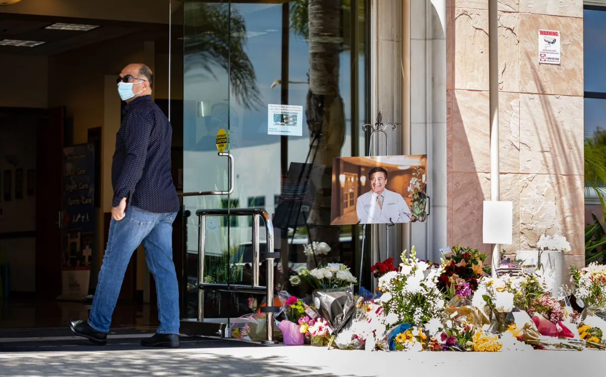 A memorial site for shooting victim Dr. John Cheng sits on display at the entrance of South Bay Medical Group in Aliso Viejo, Calif., on May 17, 2022. (John Fredricks/The Epoch Times)