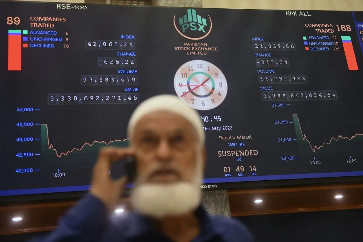 A stockbroker speaks on a phone while monitoring the share prices during a trading session at the Pakistan Stock Exchange (PSX) in Karachi, on May 16, 2022. (Tabassum/AFP via Getty Images) 