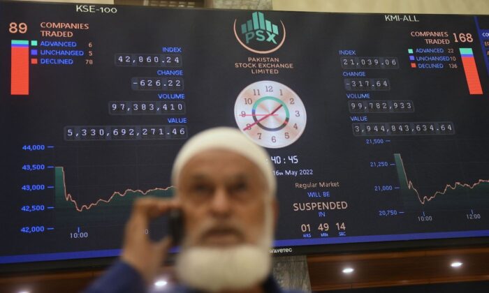 A stockbroker speaks on a phone while monitoring the share prices during a trading session at the Pakistan Stock Exchange (PSX) in Karachi on May 16, 2022. (Tabassum/AFP via Getty Images) 