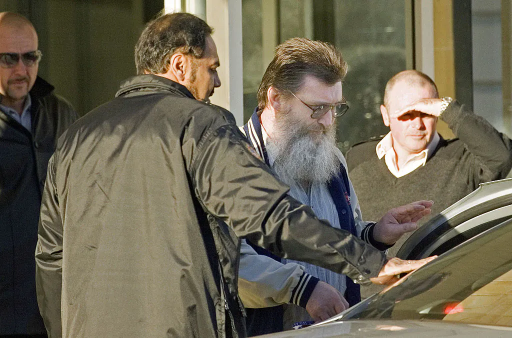 Prison officers escort convicted terrorist Jack Roche (2nd-R) to a waiting taxi as he leaves Casuarina maximum security prison in Western Australia on May 17, 2007 after having served his minumum jail term. (TONY ASHBY/AFP via Getty Images)