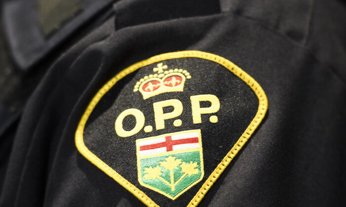An Ontario Provincial Police logo is seen during a press conference in Barrie, Ont., on April 3, 2019. (The Canadian Press/Nathan Denette)