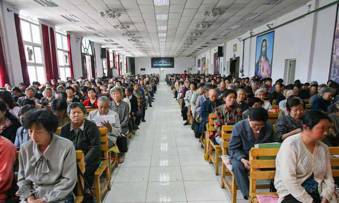 Christians pray during a mass at a church in Xining, Qinghai Province, northwest China, on July 3, 2005. China officially sanctions five religious groups: Protestant and Catholic Christianity, Islam, Buddhism, and Taoism. Chinese are allowed to worship only in state-sanctioned churches and temples. (China Photos/Getty Images)