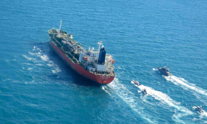 A picture obtained by AFP from the Iranian news agency Tasnim on Jan. 4, 2021, shows the South Korean-flagged tanker being escorted by Iran's Revolutionary Guards navy after being seized in the Gulf. (Tasnim News/AFP via Getty Images)