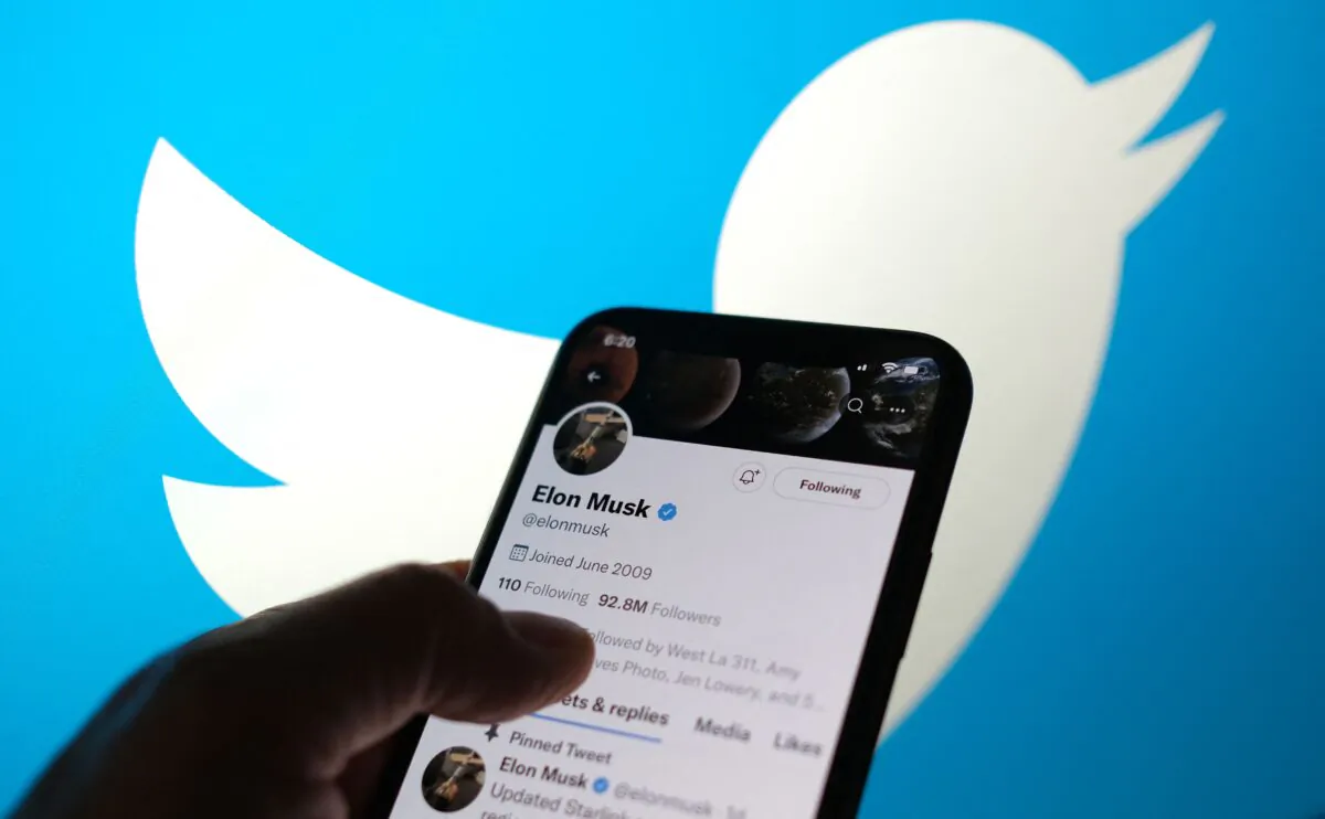 Elon Musk's Twitter account with a Twitter logo in the background in Los Angeles, Calif., on May 13, 2022. (Chris Delmas/AFP via Getty Images)