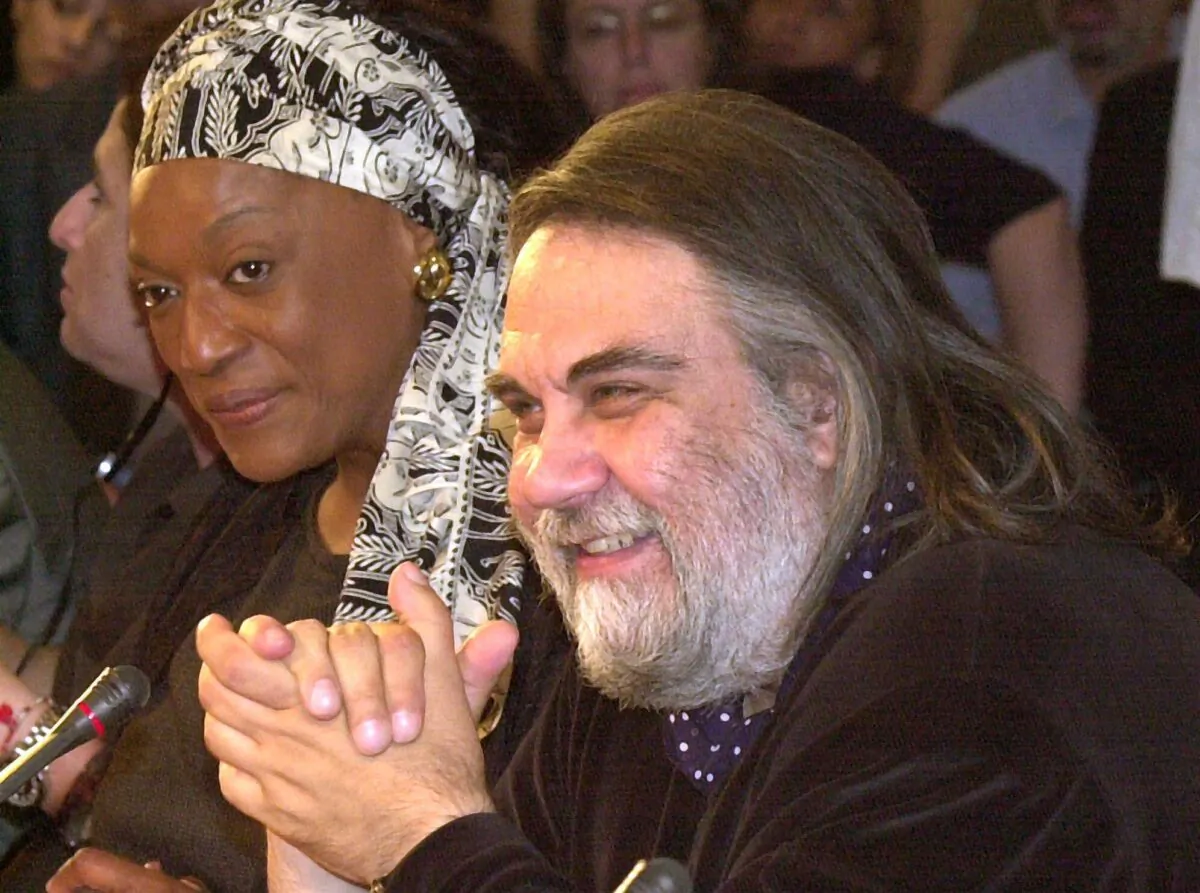 Composer Vangelis Papathanassiou (R) answers a question during a press conference in Athens on June 27, 2001. (Aris Messinis/AP Photo)