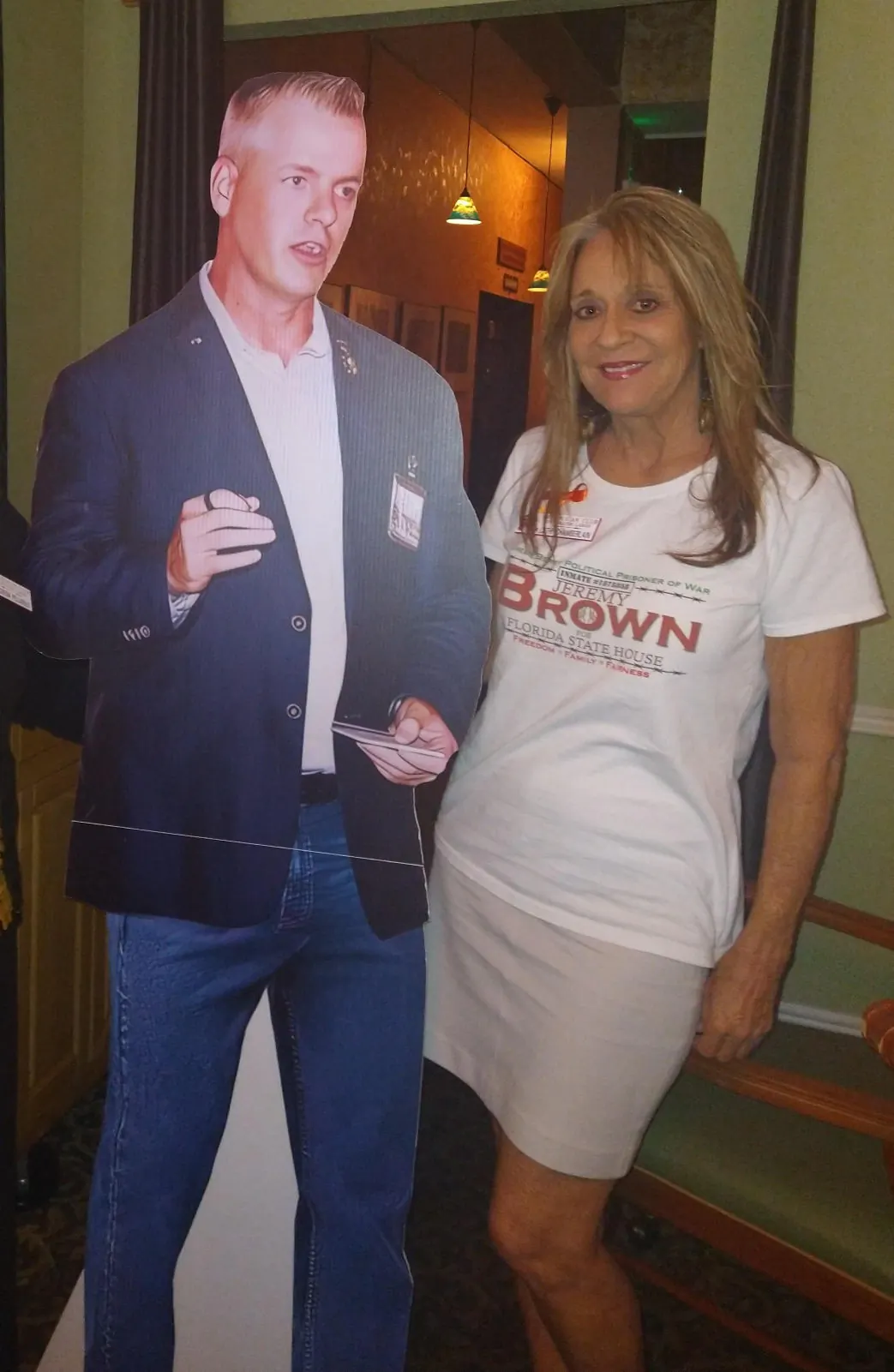 Cathi Chamberlain poses for a photo with a cardboard cutout of Jeremy Brown, a Jan. 6 prisoner and official candidate for the Florida House of Representatives in District 62. Chamberlain is Brown's "campaign commander." (Courtesy of Cathi Chamberlain)
