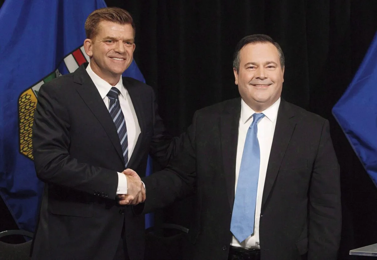 Alberta Wildrose leader Brian Jean and Alberta PC leader Jason Kenney shake hands after announcing a unity deal between the two parties in Edmonton on May 18, 2017. (The Canadian Press/Jason Franson)