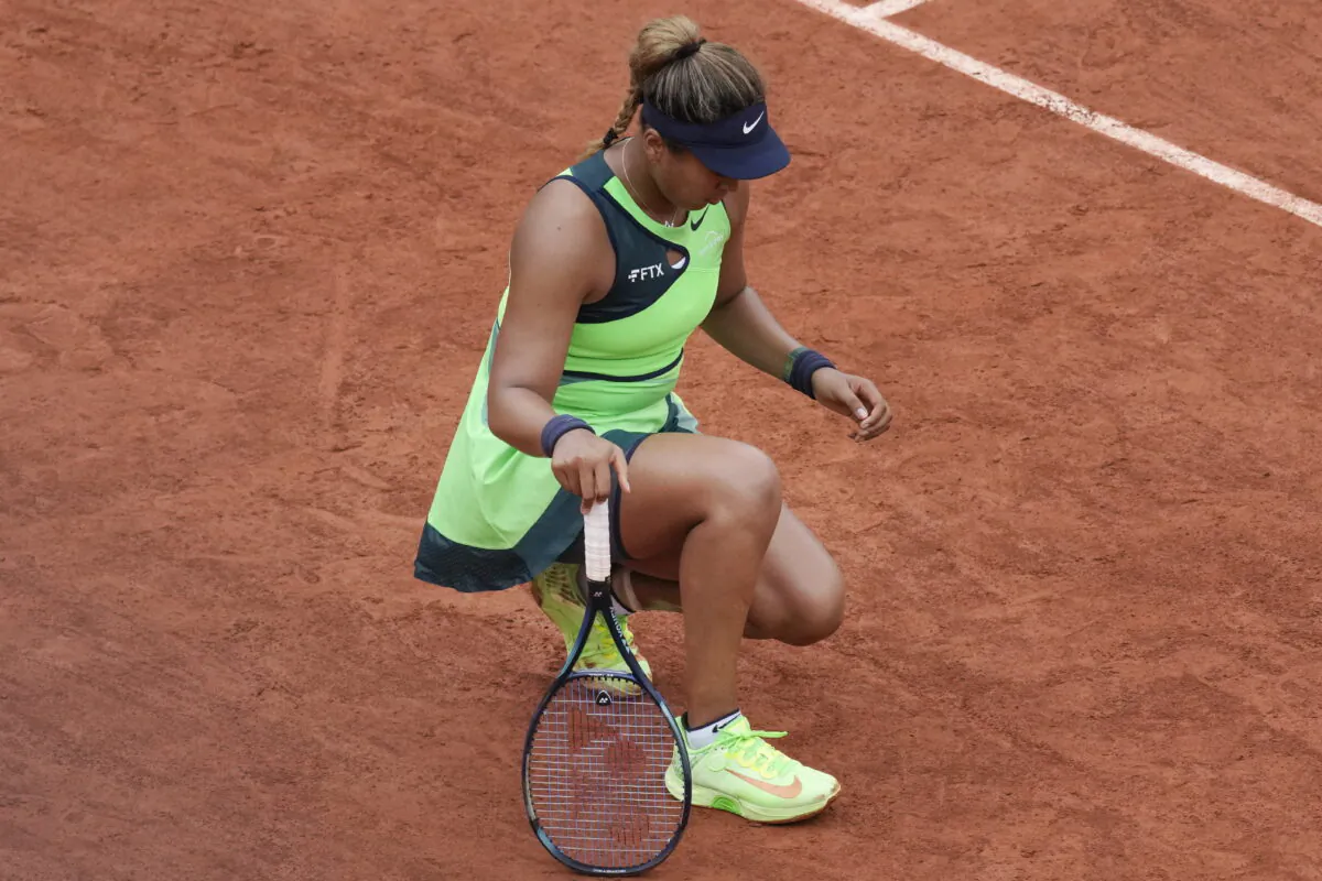 Japan's Naomi Osaka stretches her left foot during her first round match against Amanda Anisimova of the United States at the French Open tennis tournament in Roland Garros stadium in Paris, on May 23, 2022. (Christophe Ena/AP Photo)