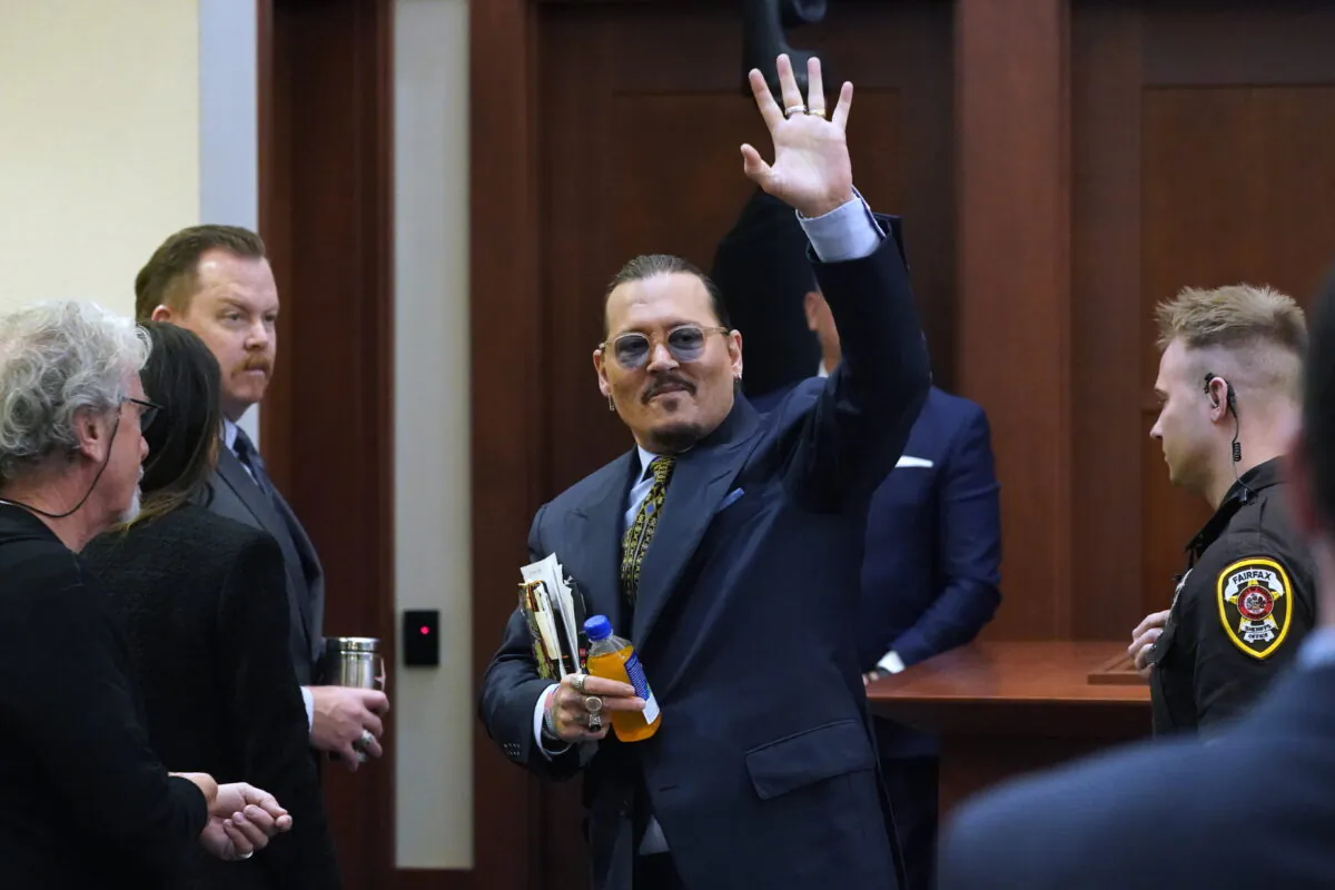 Actor Johnny Depp gestures to the gallery as he leaves for a break in the courtroom at the Fairfax County Circuit Courthouse in Fairfax, Va., on May 23, 2022. (Steve Helber/Pool via AP Photo)
